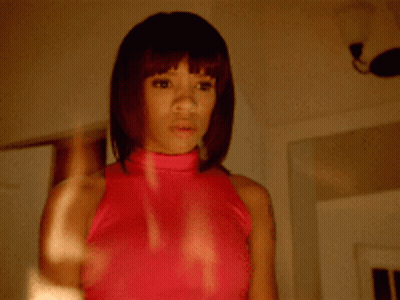 Woman In Pink Top Looking In Mirror GIF