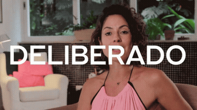 Woman In Pink Top On Couch Deliverado Sign GIF