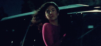 Woman In Pink Top Sitting In Back Of Car GIF