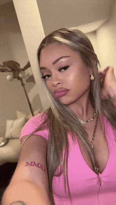 Woman In Pink Top With MMXX Tattoo GIF