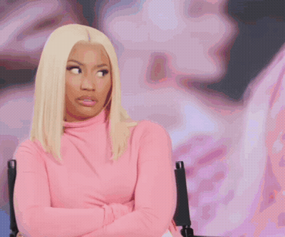 Woman In Pink Turtleneck Sitting In Front Of Picture GIF