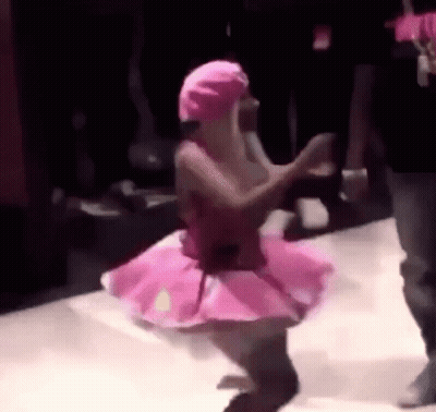 Woman In Pink Tutu Dancing In Dark Room GIF