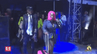 Woman In Pink Wig Walking With Pink Suitcase GIF