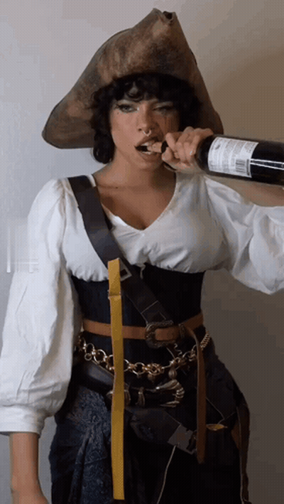 Woman In Pirate Costume Drinking Wine GIF