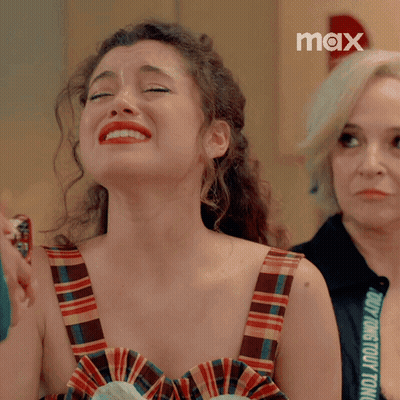Woman In Plaid Dress Crying With Max Logo GIF