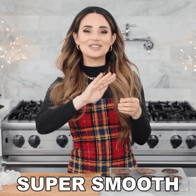 Woman In Plaid Dress Standing By Stove GIF
