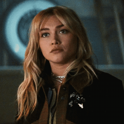 Woman In Plaid Jacket And Necklace GIF