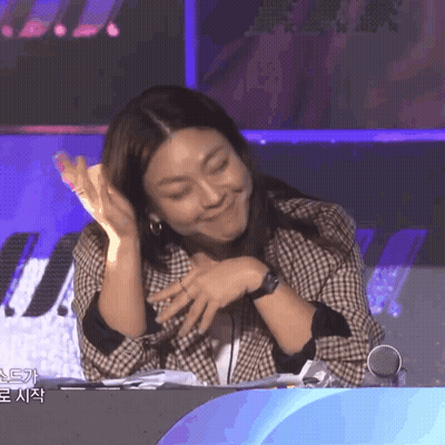 Woman In Plaid Jacket Funny Face At Microphone GIF