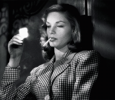 Woman in Plaid Jacket Lighting Cigarette