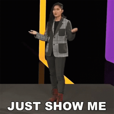 Woman In Plaid Jacket On Stage Saying Just Show Me GIF