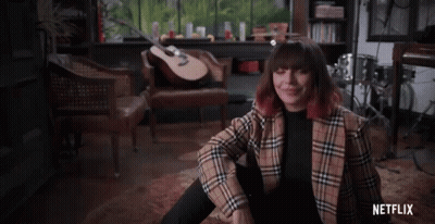 Woman In Plaid Jacket With Guitar And Netflix GIF