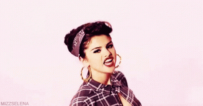 Woman In Plaid Shirt And Hoop Earrings Making Funny Face GIF