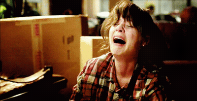 Woman In Plaid Shirt Crying In Front Of Fragile Box GIF