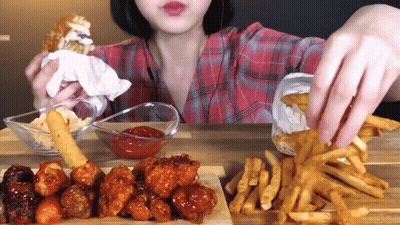 Woman In Plaid Shirt Eating French Fries And Chicken GIF