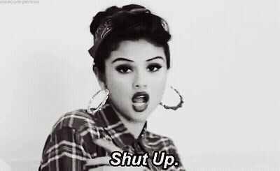 Woman In Plaid Shirt Giving Middle Finger Saying Shut Up GIF