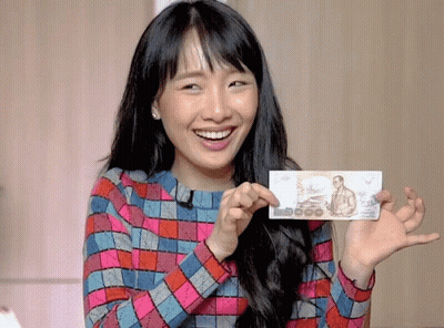 Woman In Plaid Shirt Holding 5000 Bill GIF
