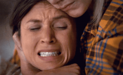 Woman In Plaid Shirt Holding Other Woman's Face GIF