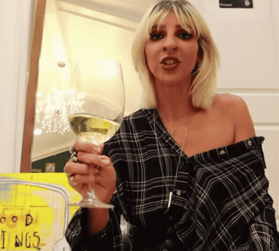 Woman In Plaid Shirt Holding Wine GIF