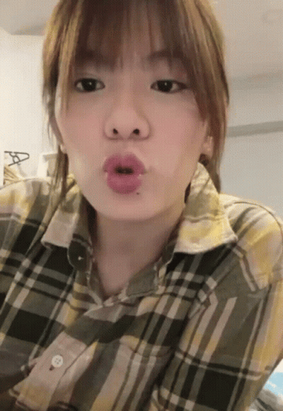 Woman In Plaid Shirt Making Face GIF