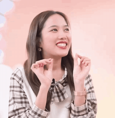 Woman In Plaid Shirt Making Heart With Hands GIF