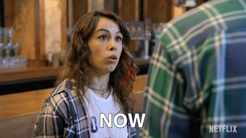 Woman In Plaid Shirt Saying Now GIF
