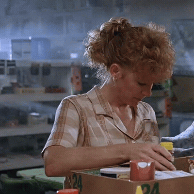 Woman In Plaid Shirt Sitting At Table With Box Number 24 GIF