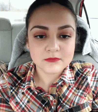 Woman In Plaid Shirt Sitting In Back Seat Of Car GIF