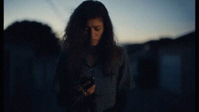 Woman In Plaid Shirt Talking On Cellphone GIF
