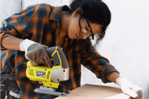 Woman In Plaid Shirt Using Jig Saw GIF