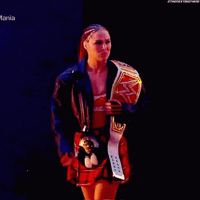 Woman In Plaid Skirt Holding Wrestling Belt GIF
