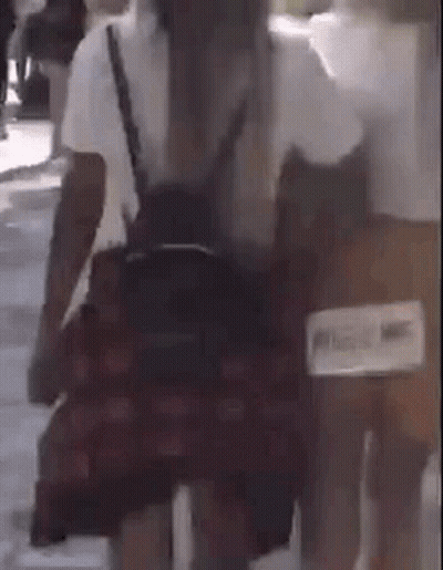 Woman In Plaid Skirt Walking With Backpack GIF