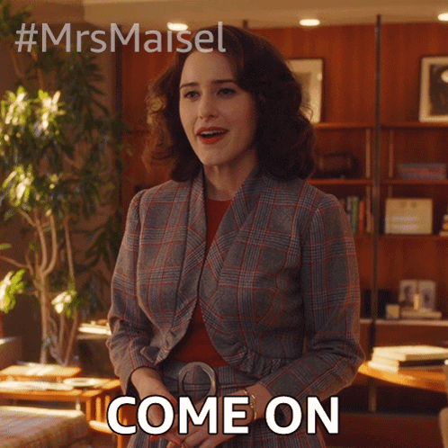 Woman In Plaid Suit Standing In Room Says Come On GIF