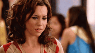 Woman In Plaid Sweater Making Funny Face GIF
