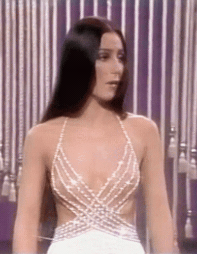 Woman In Plunging White Dress With Striped Curtain GIF
