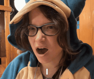 Woman in Pokemon Costume With Glasses and Letter I on Face