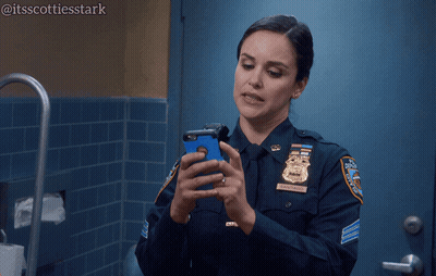 Woman In Police Uniform Holding Cell Phone Saying Still Porn GIF