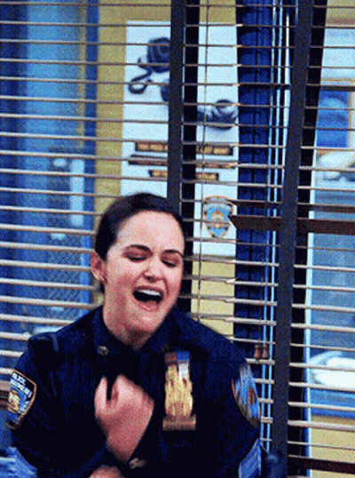 Woman In Police Uniform Laughing Behind Window GIF