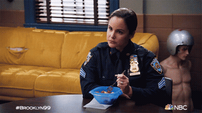 Woman In Police Uniform Sitting At Table GIF