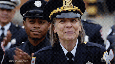 Woman In Police Uniform Smiling Next To Man GIF