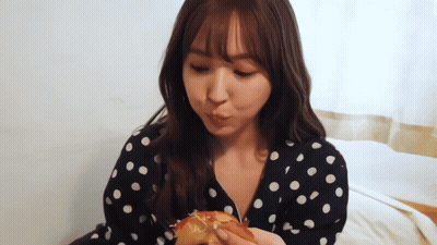 Woman In Polka Dot Dress Eating Hamburger GIF