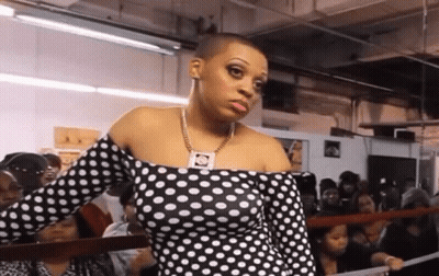 Woman In Polka Dot Dress In Crowd GIF