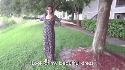 Woman In Polka Dot Dress Standing In Front Of Tree GIF