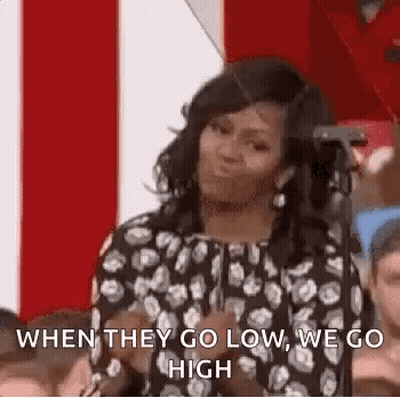 Woman In Polka Dot Dress Talking At Microphone GIF