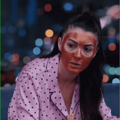 Woman In Polka Dot Pajama Shirt And Red Face Mask GIF