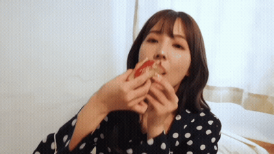 Woman In Polka Dot Shirt Eating Pizza GIF