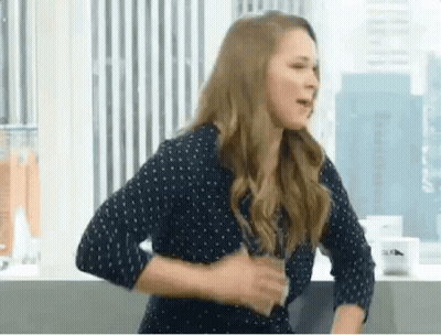 Woman In Polka Dot Shirt Holding Water GIF