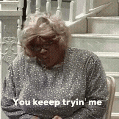 Woman In Polka Dot Shirt Sitting On Stairs GIF