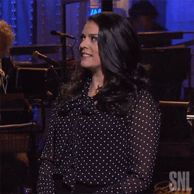 Woman In Polka Dot Shirt With SNL Logo GIF