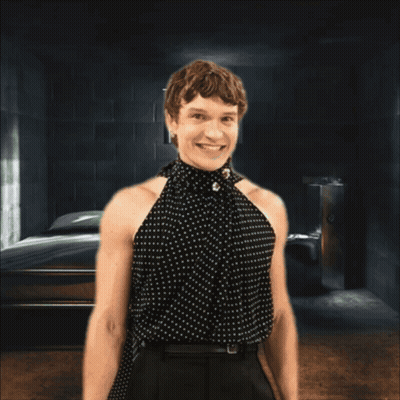 Woman In Polka Dot Top Smiling Behind Bars GIF