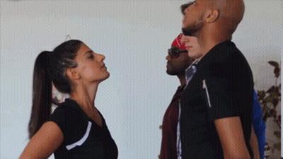 Woman In Ponytail Looking Up At Man In Black Shirt GIF